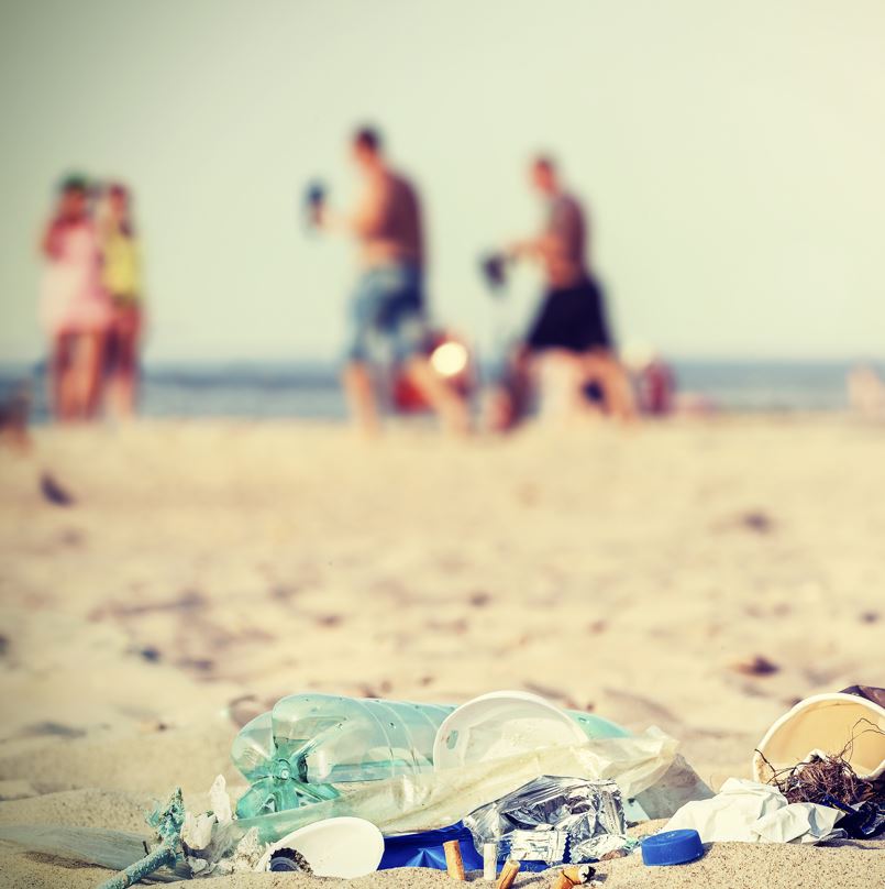 people playing on the beach with trash