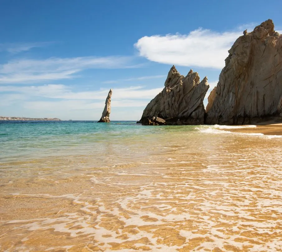  Beach with rock formations and blue water