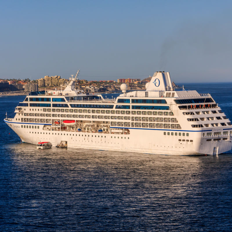 Large cruise ship floating offshore in Cabo San Lucas