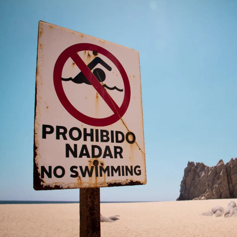 Sign on beach in Los Cabos warning people not to swim