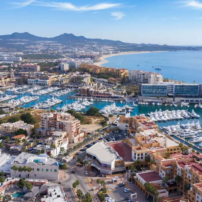 Aerial View of Cabo with buildings and the water in the background.