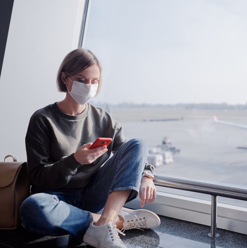 Woman in airport wearing a mask