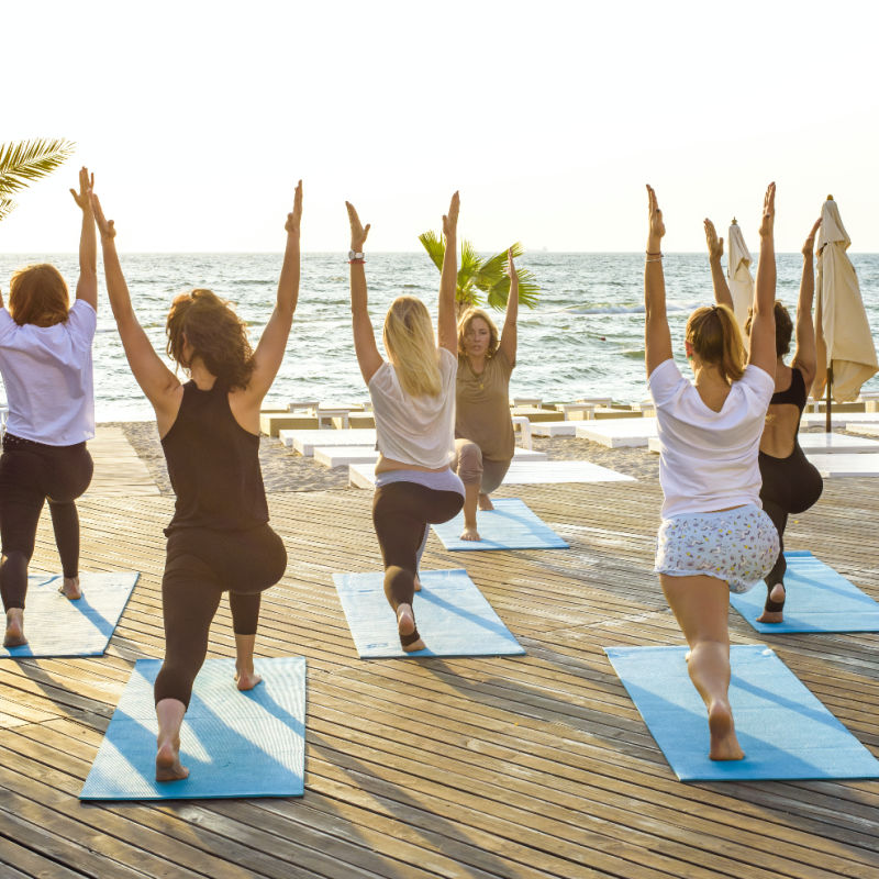 Tourists Doing Yoga on the Beach in Cabo