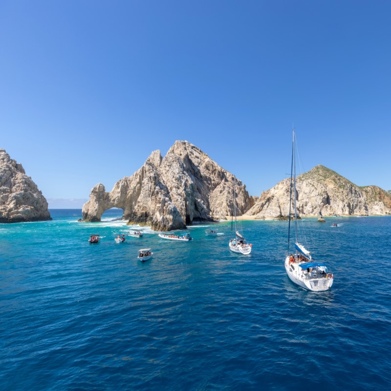 Cabo Boat Tours on the water with a view of Land's End and the famous Arch of Cabo San Lucas.