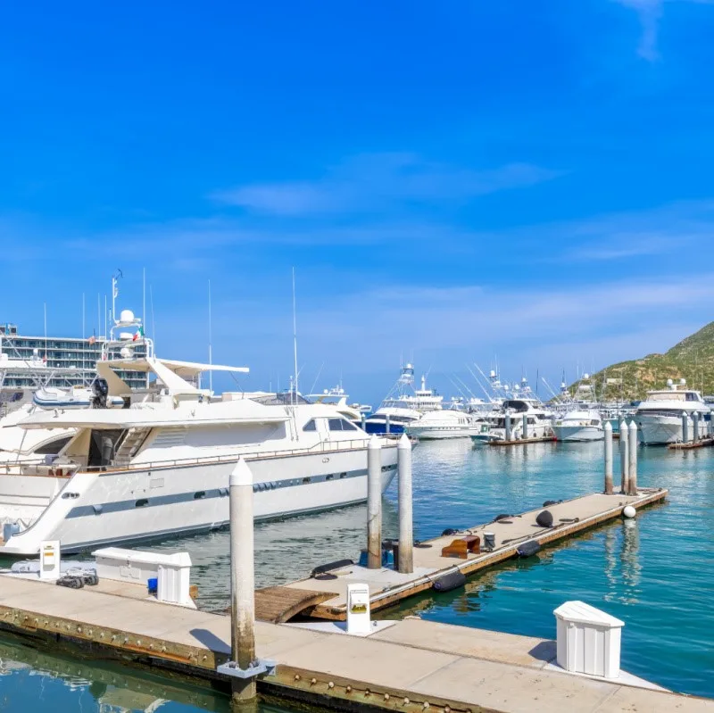 Boats in Cabo San Lucas marina with a dock.