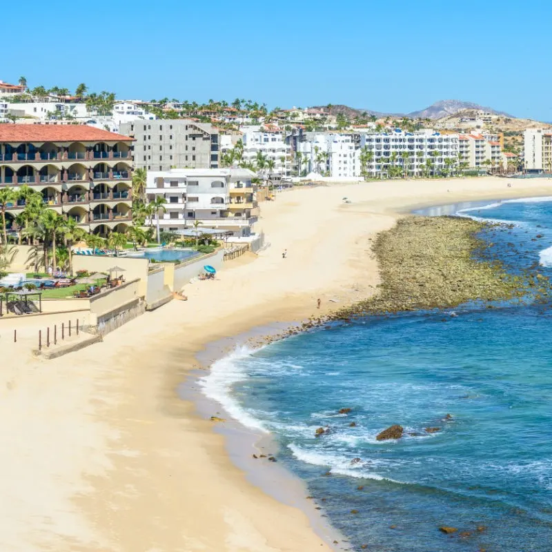 Cabo Resorts along a beautiful sandy beach.