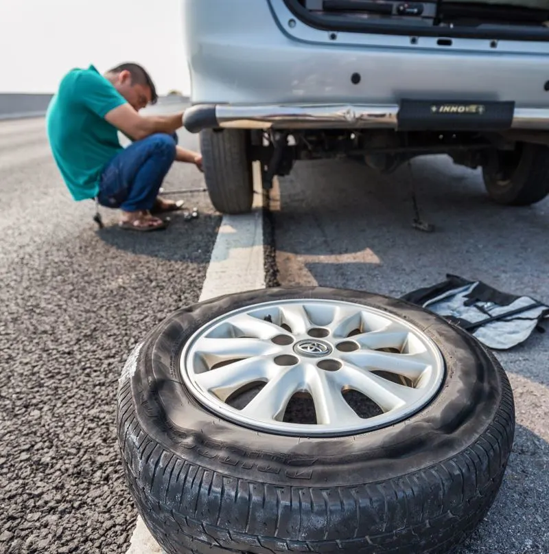 Fixing a flat tire due to poor roadways