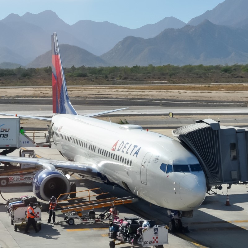 Delta Plane at Los Cabos Airport with Mountains in the Background