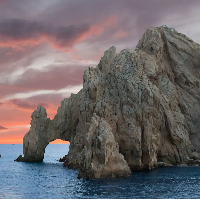 Sunset with rain clouds over the Los Cabos arch