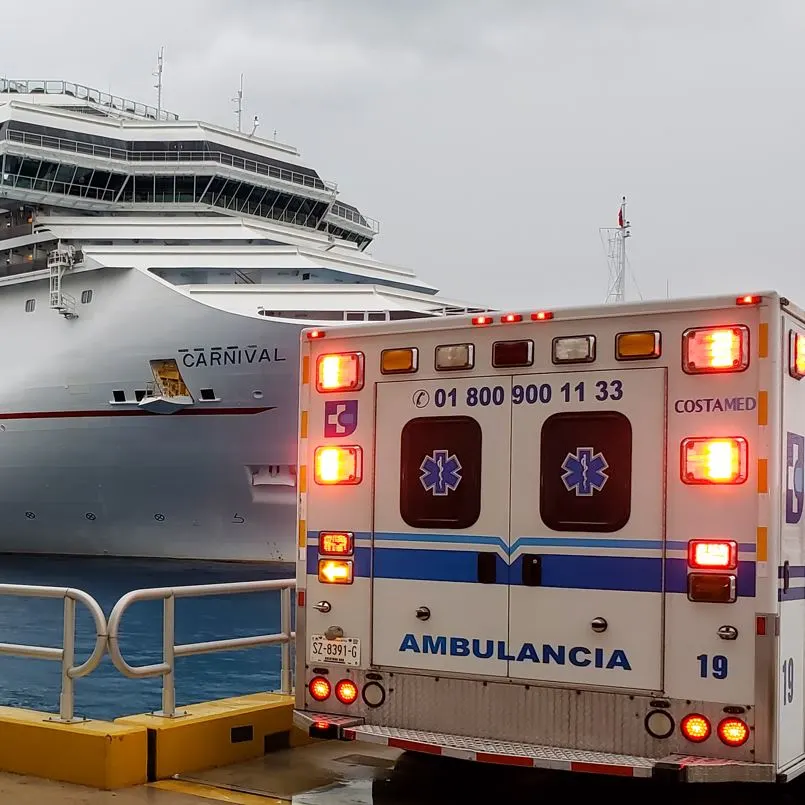 Ambuelence At Dock Next To A Large Cruise Ship