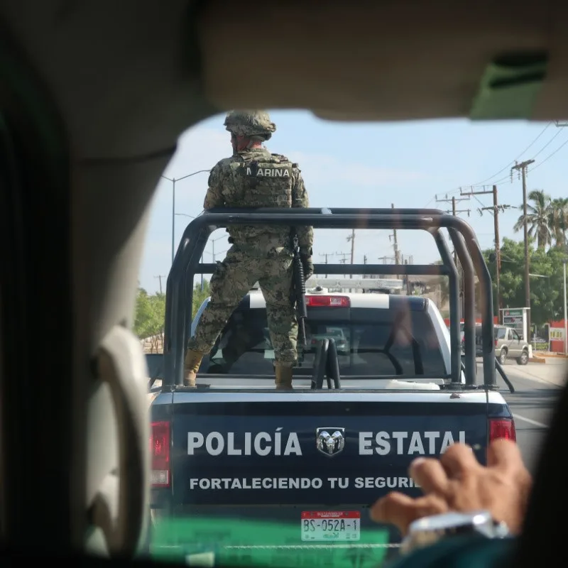 Armed Guard in Patrol Vehicle in Cabo driving down the streets.