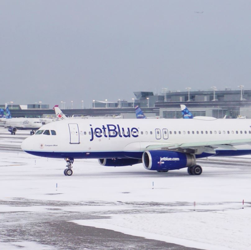 Icy Runway at JFK Airport In New York With A Jet Blue Plane