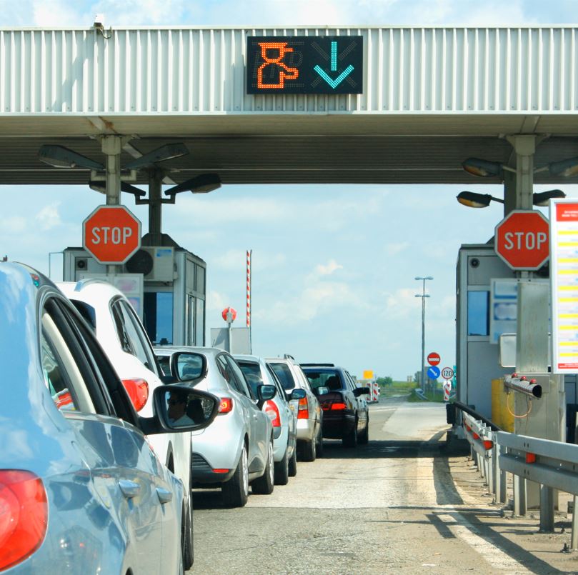 Long line a toll booth causing traffic jams