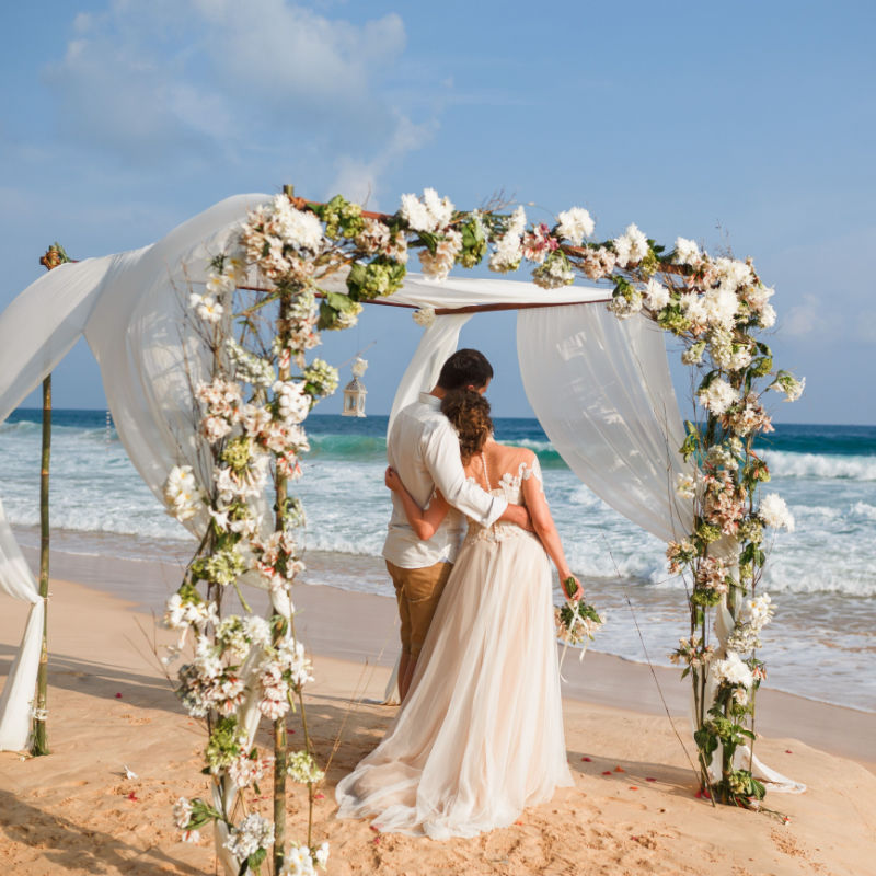 couple hugging and getting married on a beach in Los Cabos