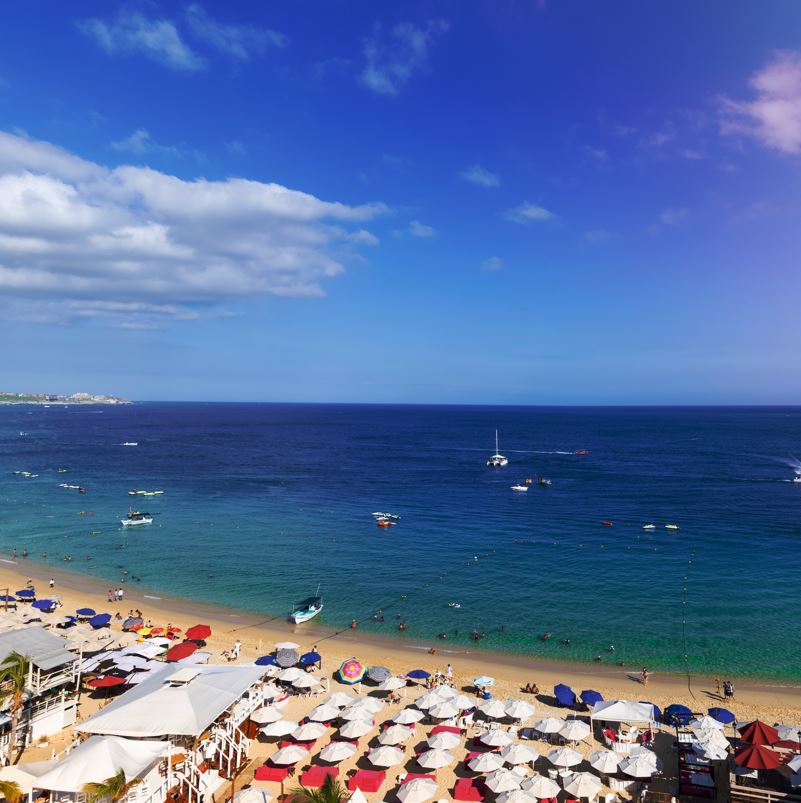 Los Cabos beach aerial view with tourists enjoying the sand and sun