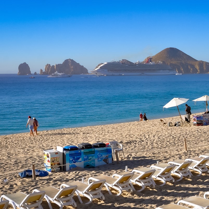 beach chairs overlooking a cruiser and other boats in the ocean