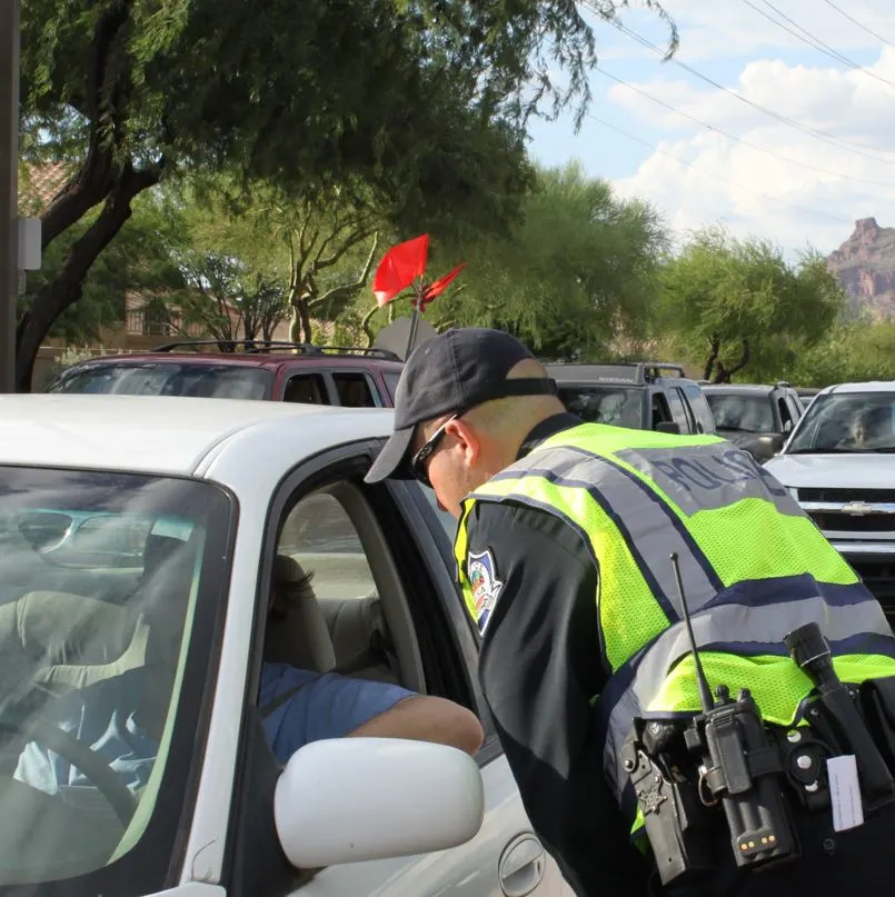 Multiple officers in a police checkpoint talking to drivers