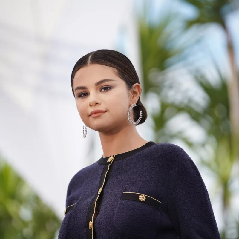 Selena Gomez at Cannes Film Festival 2019 with trees in the background.
