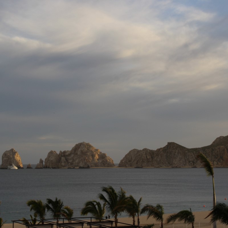 Cloudy Day in Cabo San Lucas with a view of the beach, the sea, and the famous Arch of Cabo San Lucas.
