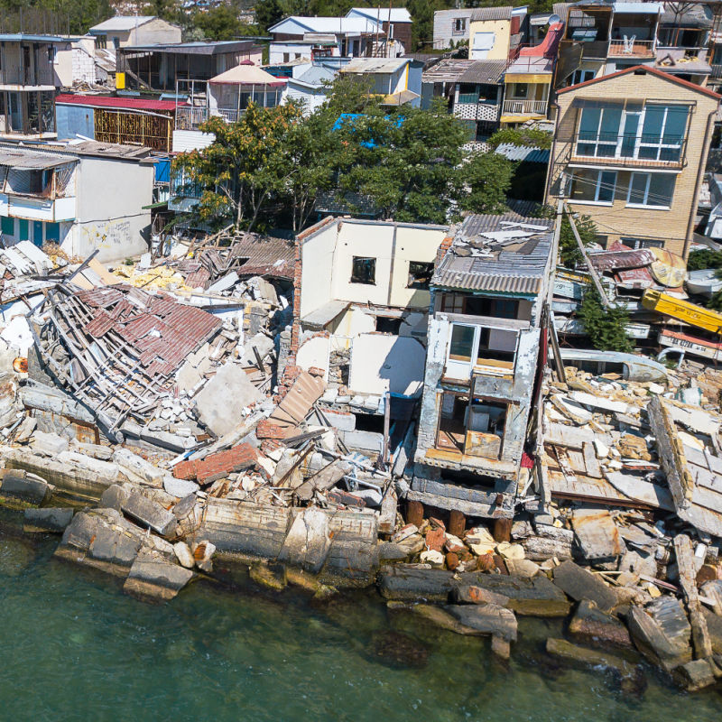 Collapsed buildings and houses along the coastline caused by earthquake, Los Cabos concept