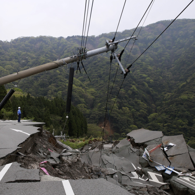 Road in the jungle destroyed by falling power line after earthquake