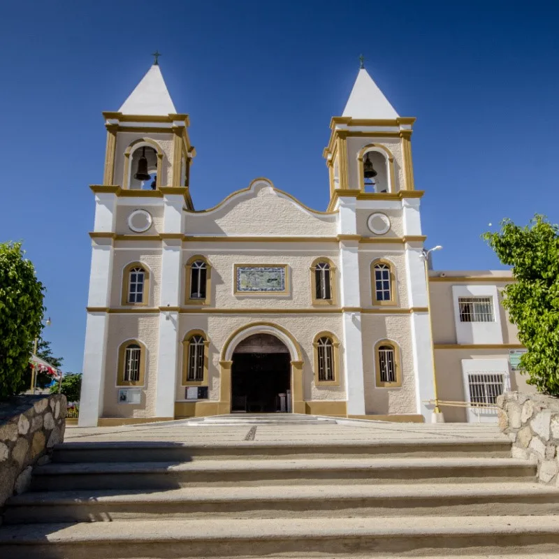 Cathedral in San Jose del Cabo, surrounded by trees.