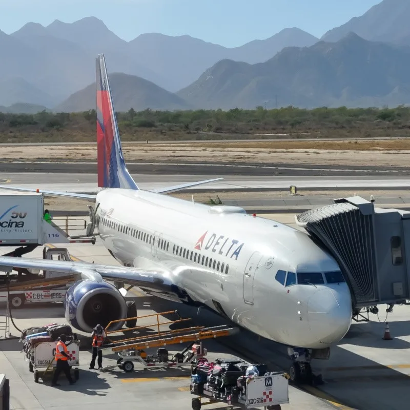 Delta Plane at Los Cabos Internaional Airport with Mountains in the Background