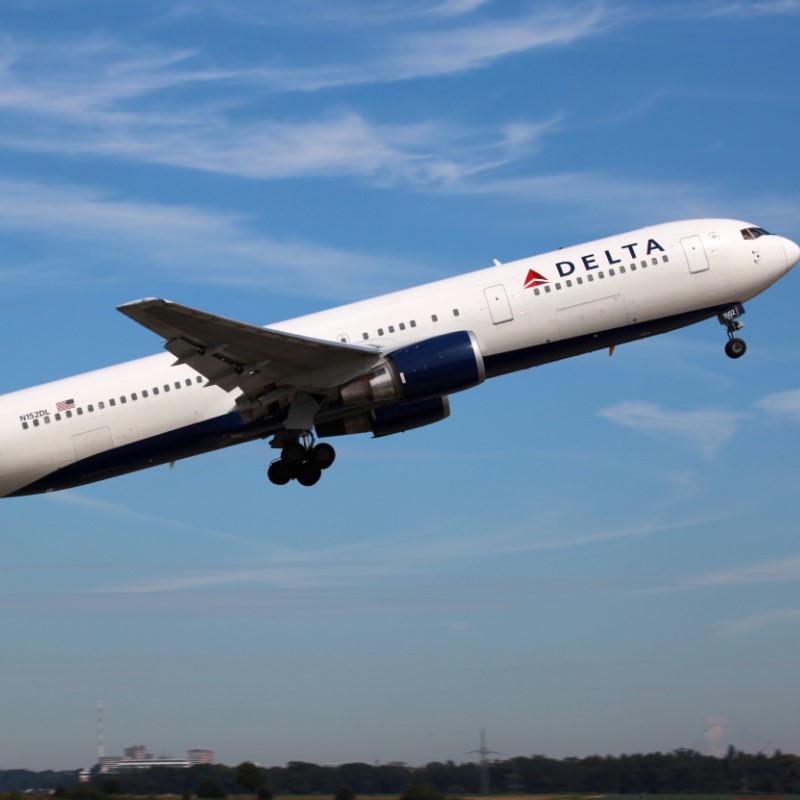 Delta Plane in the Air with the Clear Blue Sky in the Background