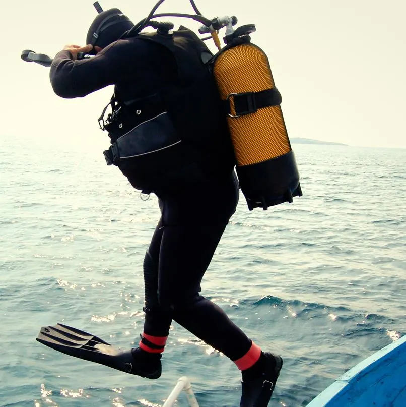 Diver jumping into the ocean from a boat
