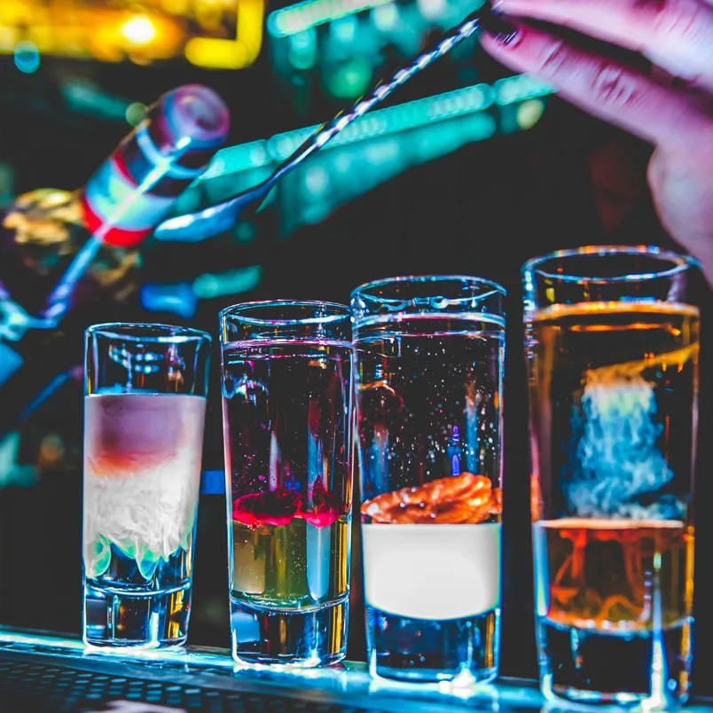 4 alcohol shots on a bar