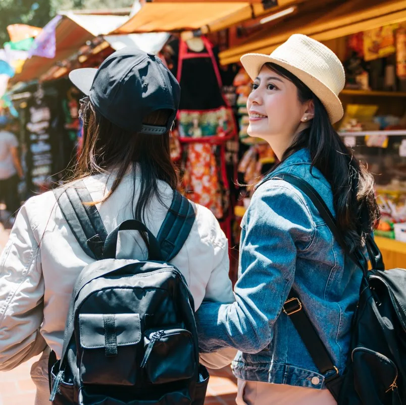 Travelers walking through a market