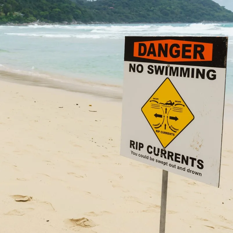 Rip current warning sign on beach