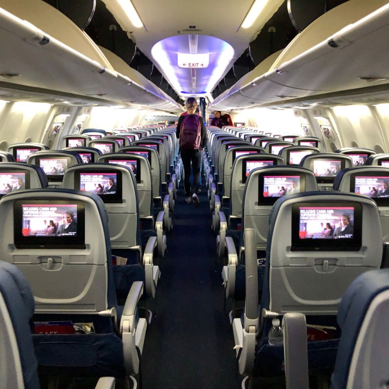 Passenger Exiting a Delta Plane After a Flight