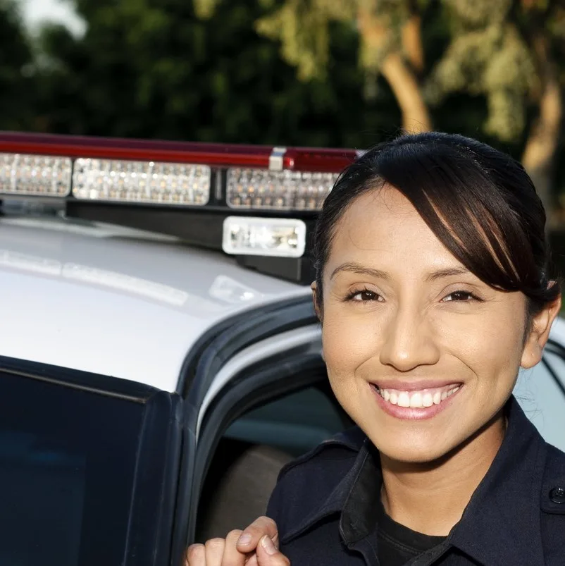 Police officer beside patrol car