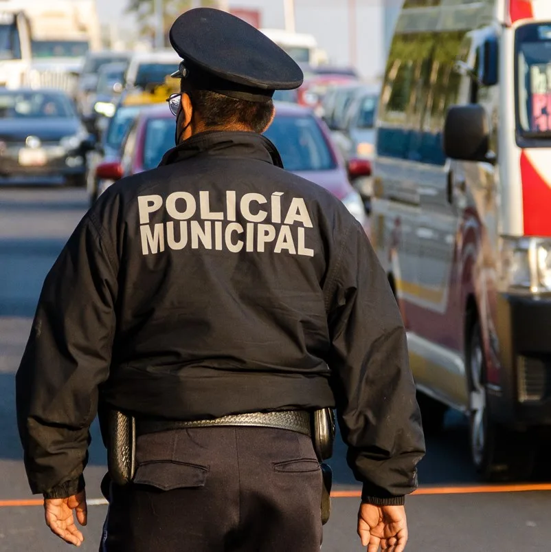 police officer dealing with traffic in a Mexican street. 