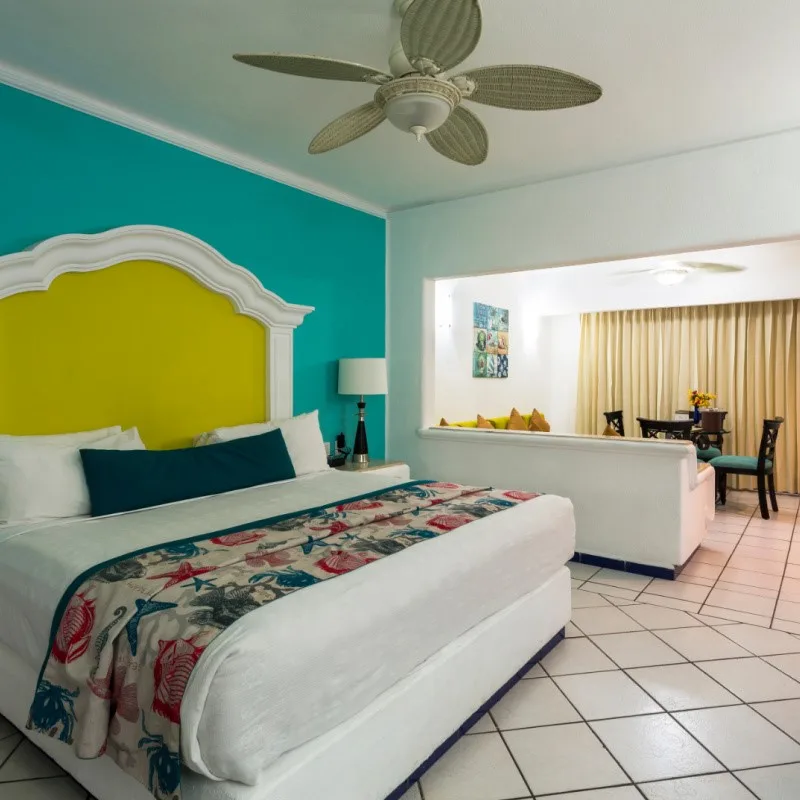 Room at a Resort in Cabo San Lucas with a Dining Table in the Background.