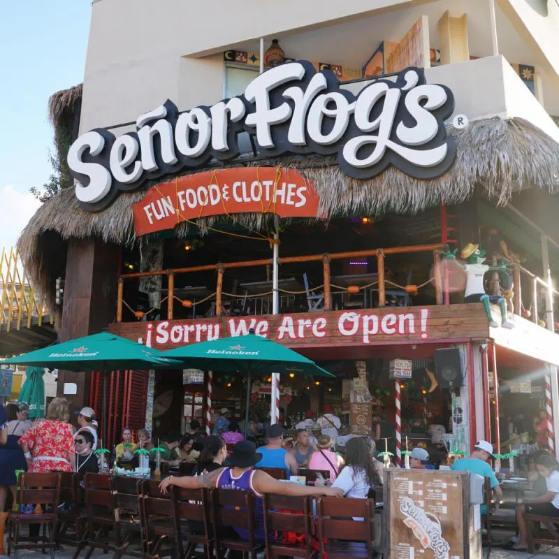 Tourists sitting in front of Senor Frogs in Cabo San Lucas.