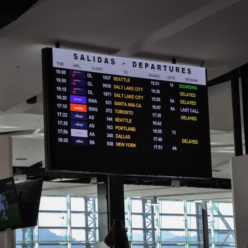 Departure Board at Los Cabos Airport Showing Delayed Flights