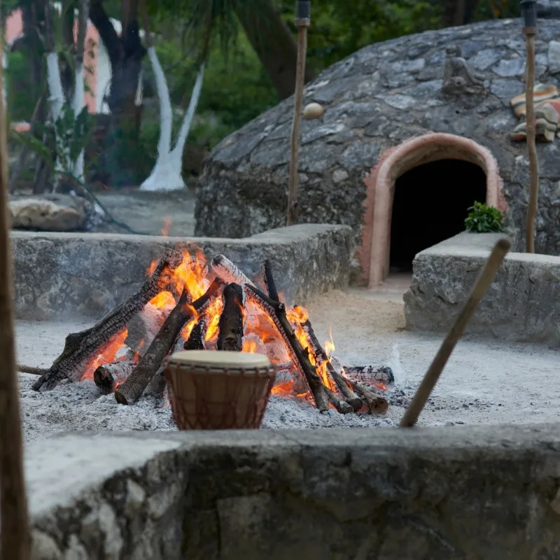 Temazcal Ceremony Preparations with fire burning in Mexico.