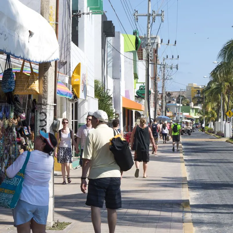 Tourists window shopping on the streets of a Mexican beach town