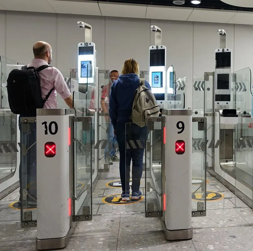 Travelers going through electronic immigration gates
