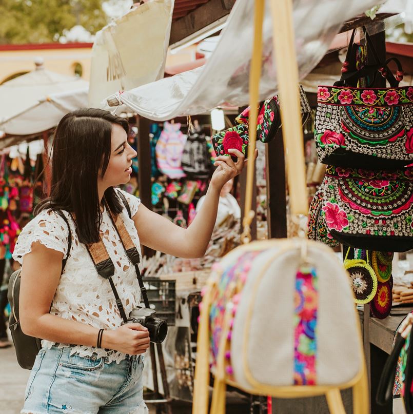 Woman looking at items at a market in mexico