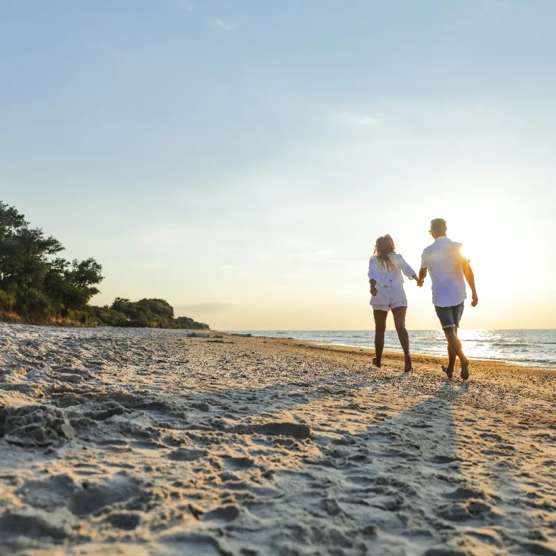 Couple walking along the beach in Los Cabos