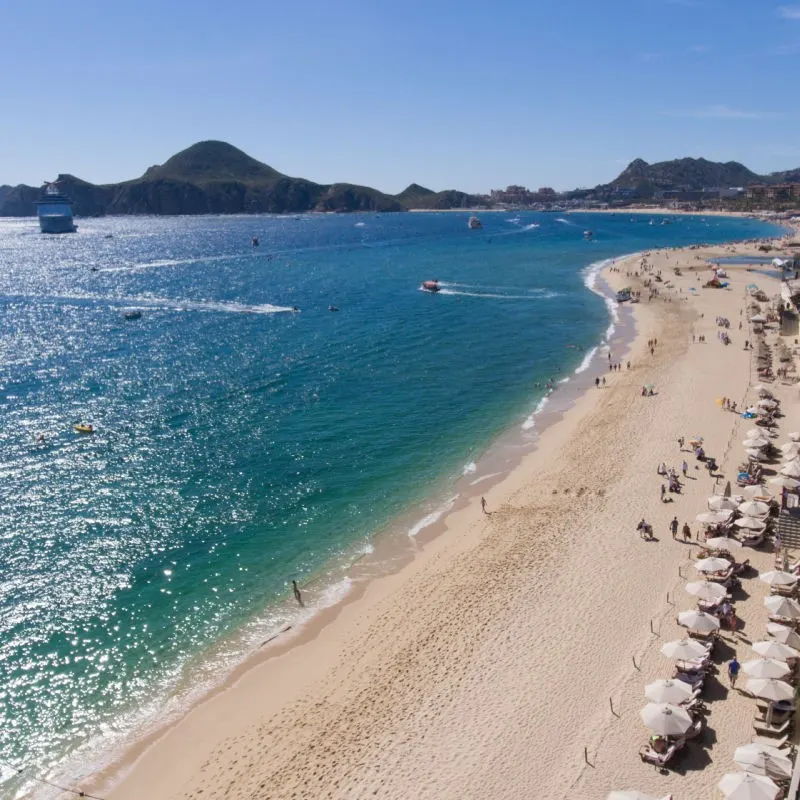 Beautiful Aerial View of Cabo San Lucas with Tourists on the Beach and Boast in the Water