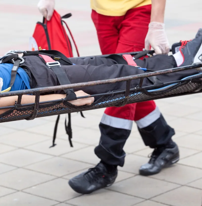 Man being carried in stretcher