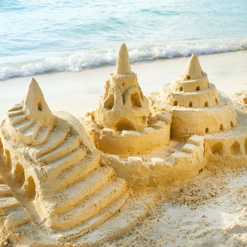 Sand Castle on the Beach with the Sea in the Background