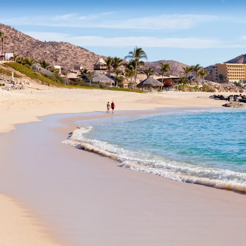 Couple Walking Down the Beach in Cabo San Lucas