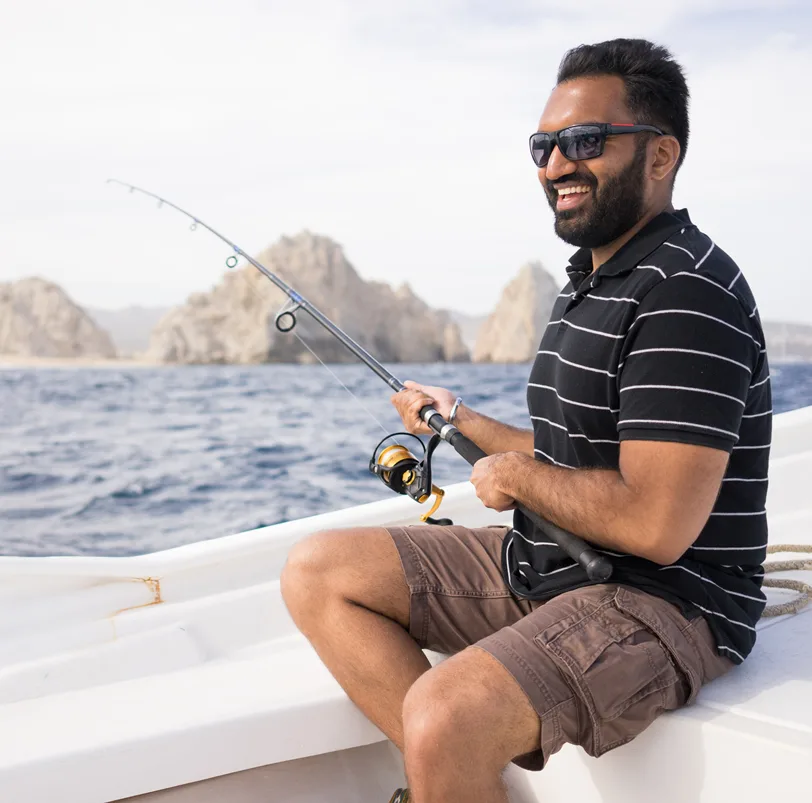 Man sportfishing near Los Cabos arch