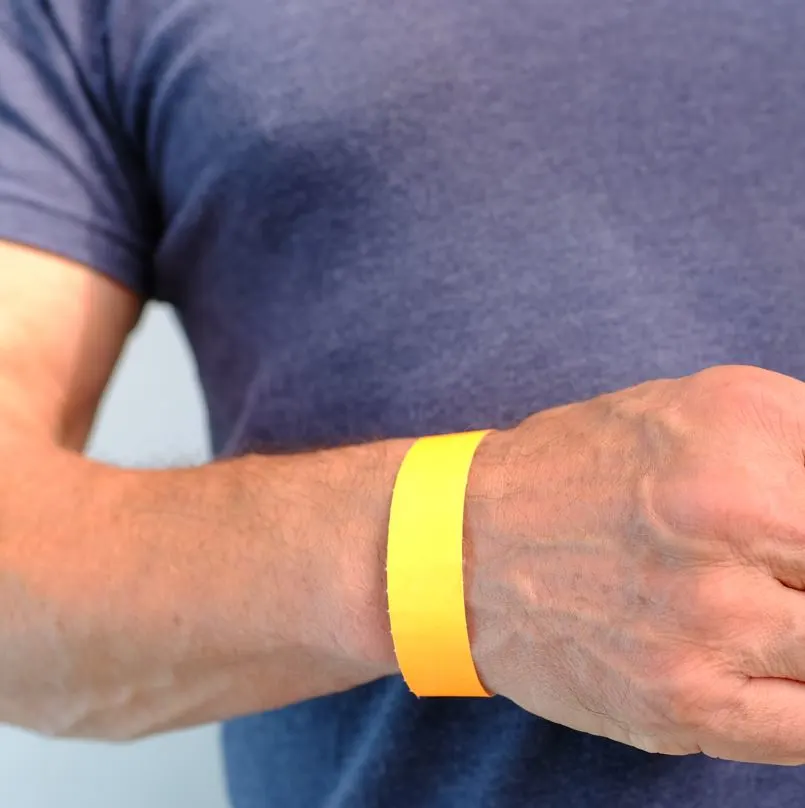 person wearing a yellow bracelet