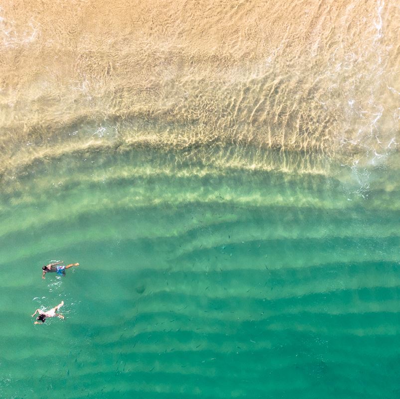 Aerial view of people swimming in cabo